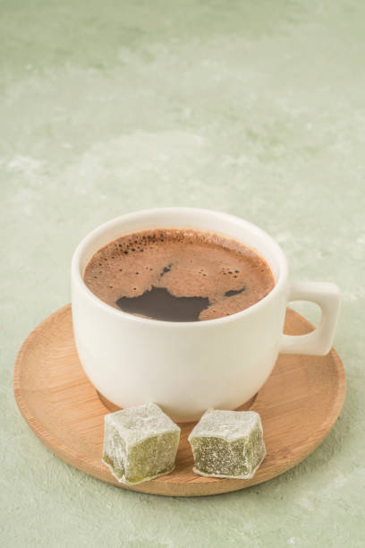 istock Cup of coffee served with Turkish delights on green 1221631900