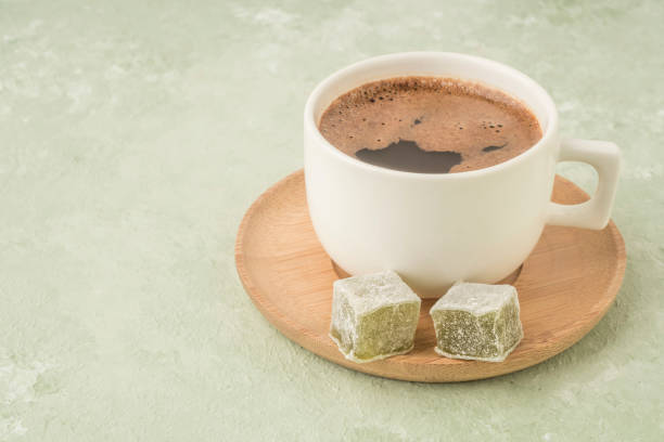 istock Cup of coffee served with Turkish delights on green 1221631906