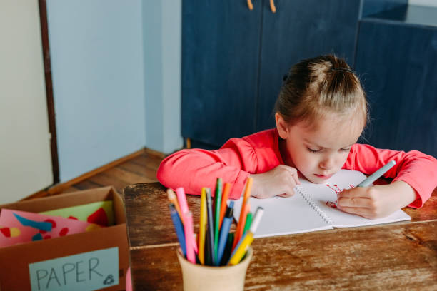 istock Little girl drawing at home 1221632749