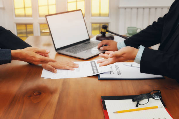 istock The lawyer submits a contract document to the client at table in office. Sign a contract business. Treaty of the law. 1221632772