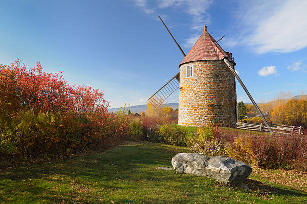 Windmill An old windmill on Isle aux Coudres, Quebec, Canada old flour mill stock pictures, royalty-free photos & images