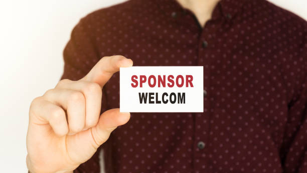 istock Businessman holding a card with text SPONSOR WELCOM. 1221634801