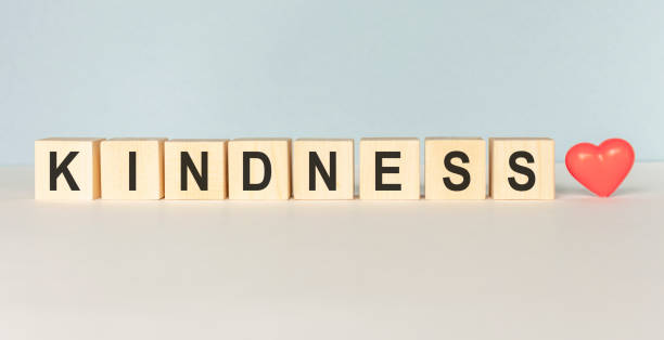 kindness word written in wooden cube on a light background - single word love wood typescript imagens e fotografias de stock