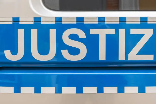 a police car in germany labeled with the word justice