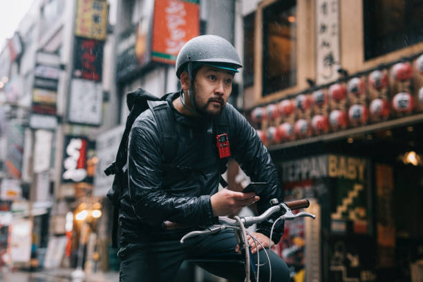 istock Bike Messenger Checking for Directions on a Smartphone 1221635079