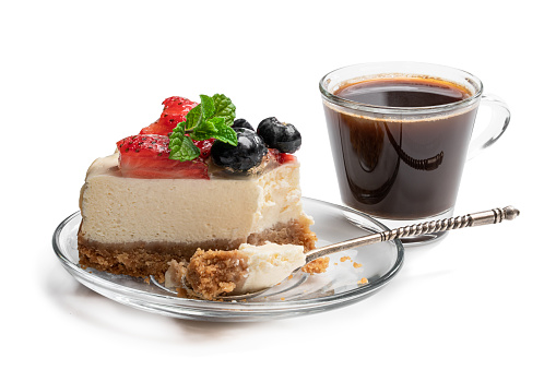 Slice  of creamy cheesecake with jellied berries on top isolated on white