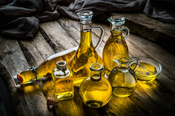 istock Olive oil bottles collection on rustic wooden table 1221635212
