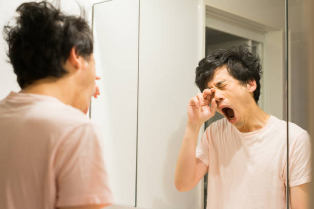 Asian man giving a big scream in front of the sink mirror in the morning Asian man giving a big scream in front of the sink mirror in the morning.
He has Bedhead. tangled photos stock pictures, royalty-free photos & images