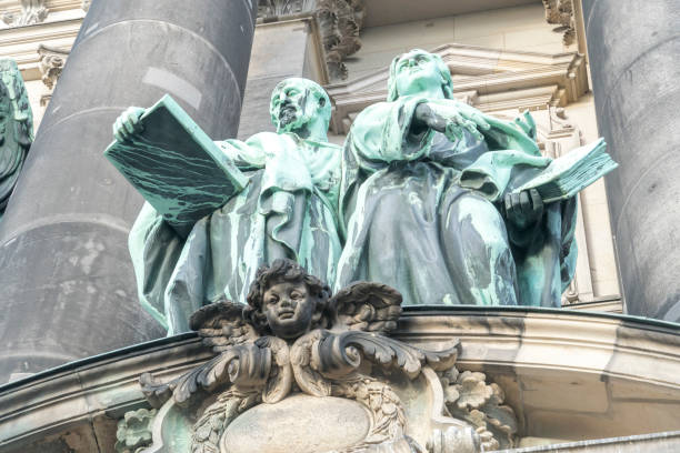 Copper statues of disciples Luke and John designed by Gerhard Janensch and Johannes Gotz on the main facade of the Berlin Cathedral, Germany