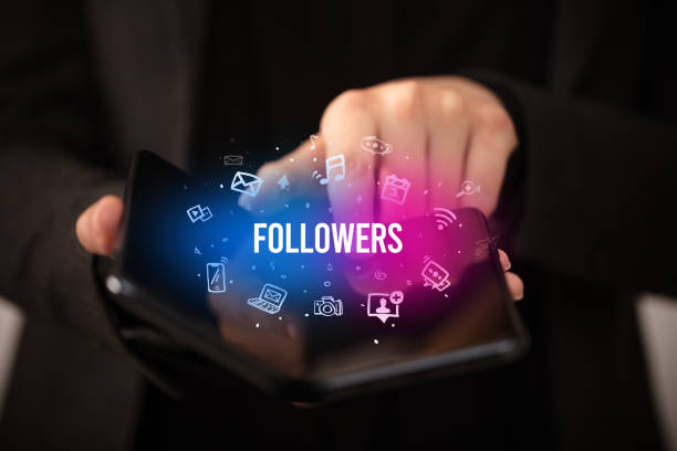 istock Businessman holding a foldable smartphone, social media concept 1221637266
