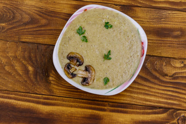 istock Mushroom cream soup on a wooden table. Top view 1221637296