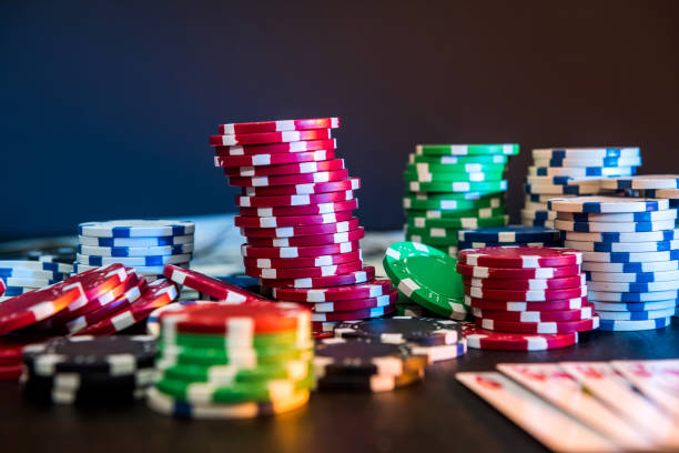 istock Poker chips and playing card on black table 1221637605
