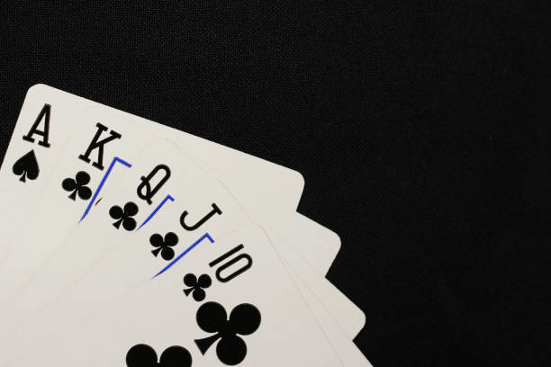 istock A royal straight flush playing cards poker on a black background 1221638556