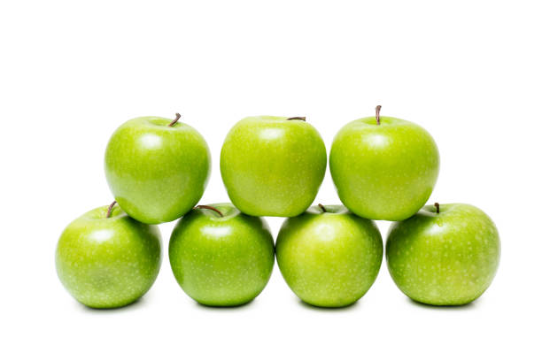 istock Green apples stacked isolated on white background 1221639441