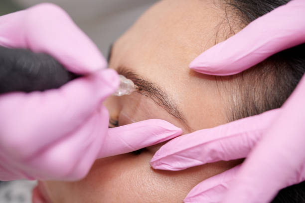 istock Female permanent eyeliner tattoos enhancement coloring in spa selective focus 1221639508
