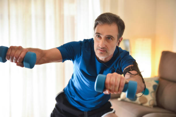 istock Man doing sports with dumbbells at home datail 1221641409