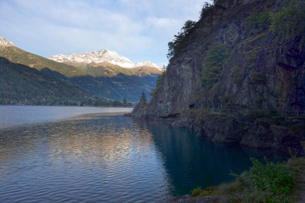 istock A cave in a rock, lake in the Poschiavo 1221641456