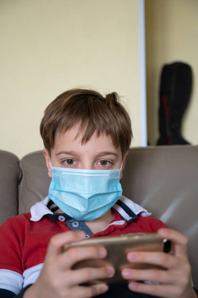 istock Boy with mask at home 1221644686