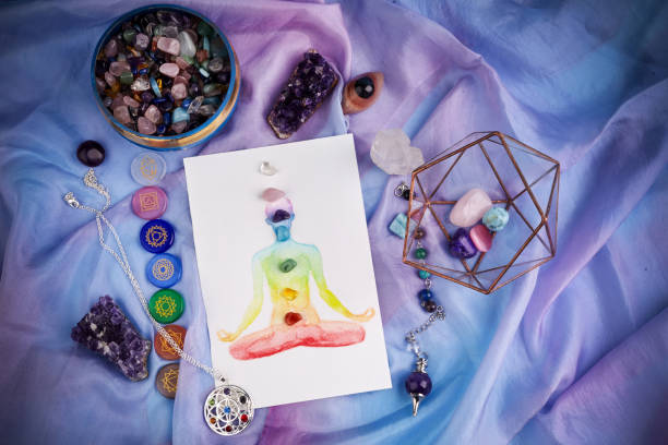 Natural crystals and pendulum on pastel silk background. Reiki background with card. Natural crystals and pendulum on pastel silk background. Reiki background with card. Top view chakra photos stock pictures, royalty-free photos & images