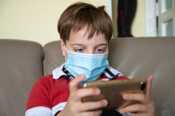 istock Boy with mask at home 1221645646