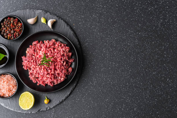 istock Fresh minced meat ground beef on a black plate against stone background 1221645965
