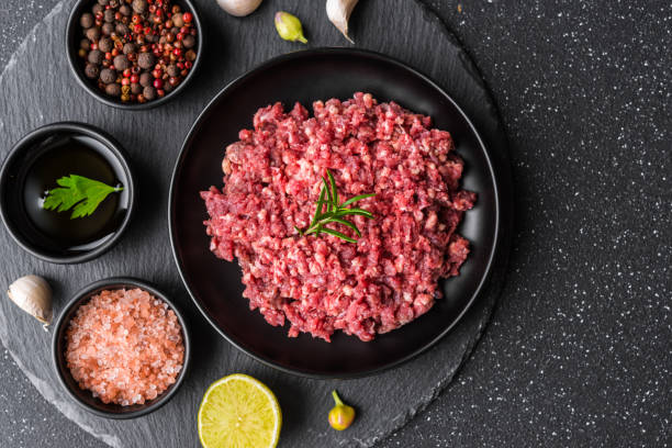 istock Fresh minced meat ground beef on a black plate against stone background 1221645967