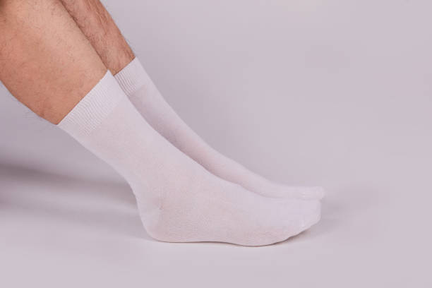 istock Man wearing new white cotton blank socks on a white background 1221646042