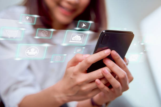 istock Concept technology internet and networking, smile woman hand holding smartphone with media icon on digital display. 1221646489