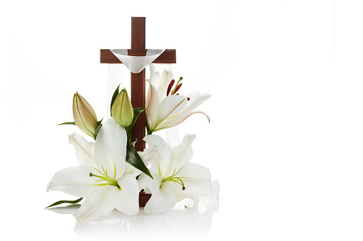 Cross with lilies on white background for decorative design. Spring background. Easter card.