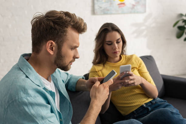 istock Selective focus of addicted couple using smartphones on couch 1221651710