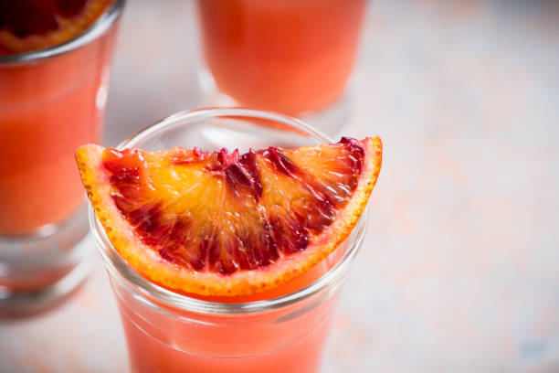 istock Strong red cocktail in shots on the rustic background 1221652864