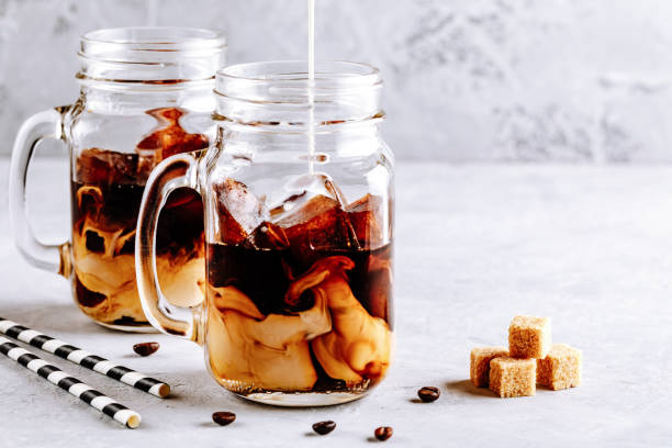 Coconut Milk Thai Iced Coffee with Coffee Ice Cubes Coconut Milk Thai Iced Coffee with Coffee Ice Cubes in Mason Jar tea with milk stock pictures, royalty-free photos & images