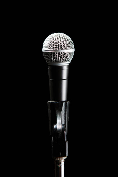 istock Black classic microphone on black dark background. Music and concert concept. 1221653378