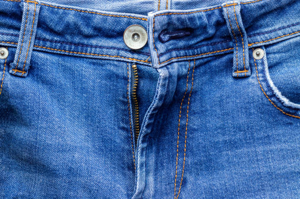 istock Jeans front with zipper open, button and pockets. Bright blue denim fabric texture background. Closeup view 1221653397