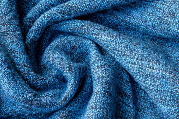 istock Bright blue knitted fabric texture. Crumpled twisted blanket background. Selective focus. Closeup view 1221653484