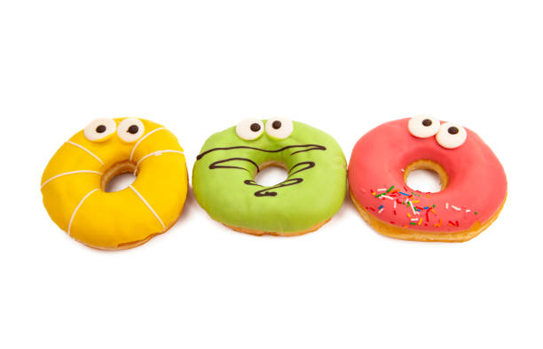 istock homemade donuts in colored glaze isolated o\ 1221655270