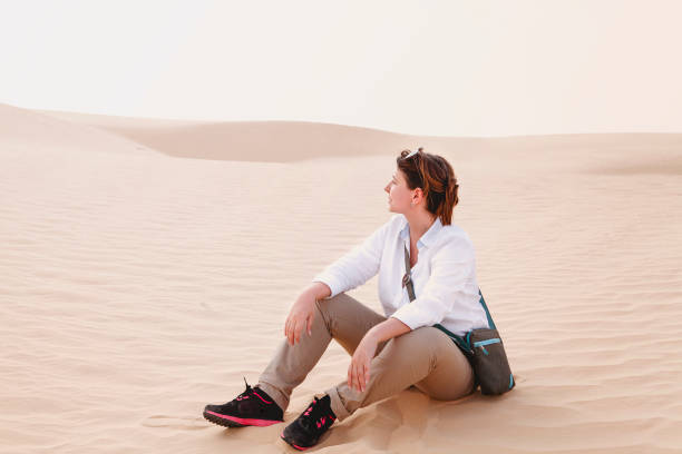 istock Calm woman sitting on sand 1221655900