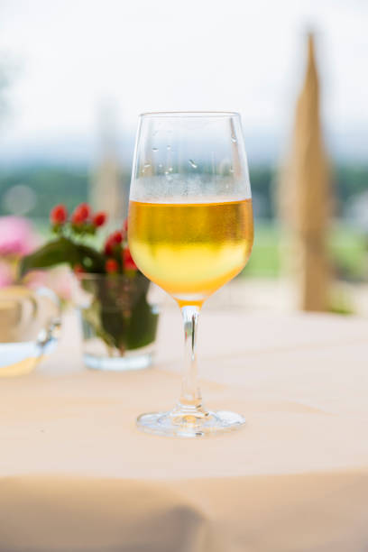 istock One wineglass with white wine on table with tablecloth 1221656232