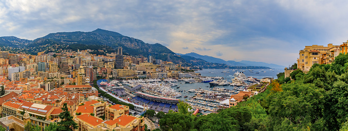 Monte Carlo, Monaco - April 20, 2016: Monte Carlo city panorama with luxury apartments and yachts in the harbor and grand stands for Monaco Grand Prix F1 race in Monaco, Cote d'Azur