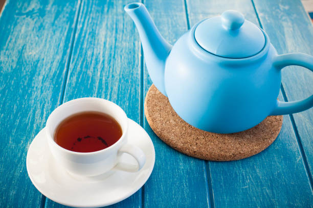istock Cup of tea with the blue teapot on the table 1221658561