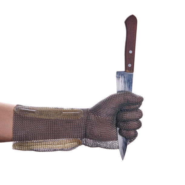 istock chain mail armor glove. person holds a kitchen knife by the blade. isolated on a white background. 1221659532