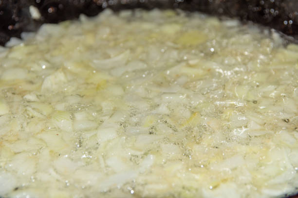 istock Finely chopped onion fried in a pan. 1221661117
