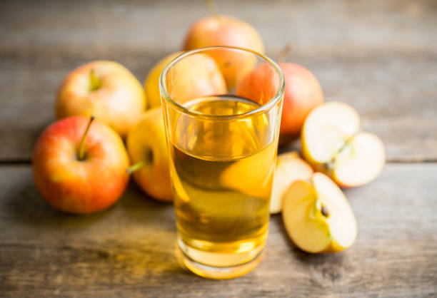 istock Apple juice with freshly harvested apples on the rustic background 1221661899