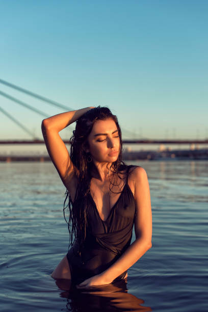 istock Brunette on the beach near the bridge 1221662080