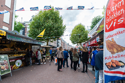 Amsterdam, Netherlands - September 8, 2018: Albert Cuyp Market, street market with people around in Amsterdam, Netherlands