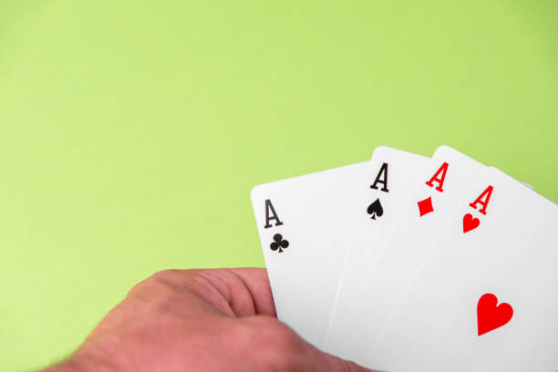 istock Four aces on green background. Concept of gambling risk. text space 1221664248