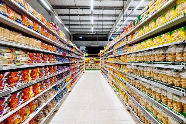 Aisles and shelves in supermarket, empty supermarket during Coronavirus lockdown Supermarket with food and groceries, ready for lockdown during COVID-19 pandemic aisle stock pictures, royalty-free photos & images