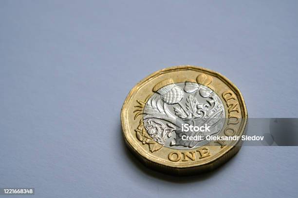 One Pound Coin Close Up Photo With Selective Focus And Dramatic Shadow Stock Photo - Download Image Now
