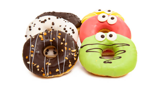 istock homemade donuts in colored glaze isolated o\ 1221668411