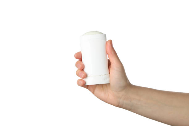 istock Female hand holds body deodorant, isolated on white background 1221668676